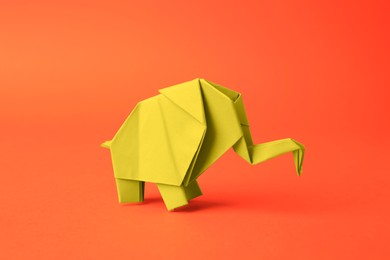 Origami art. Beautiful paper elephant on orange background