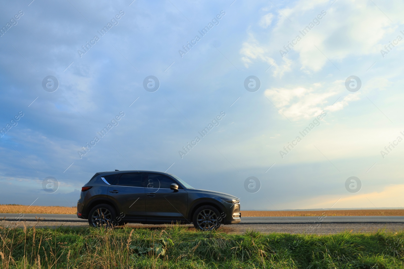 Photo of Black modern car parked on roadside, space for text