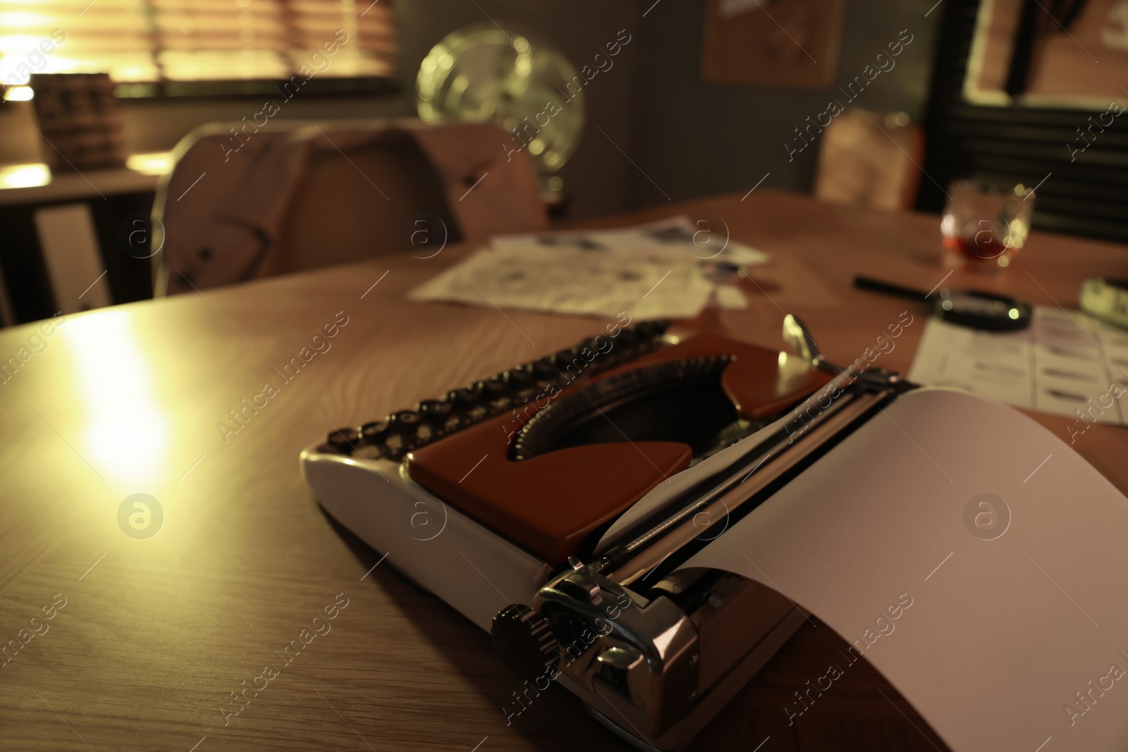 Photo of Detective workplace with vintage typewriter on wooden table