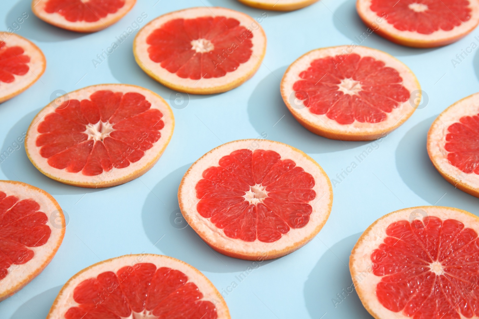 Photo of Fresh sliced ripe grapefruit on color background