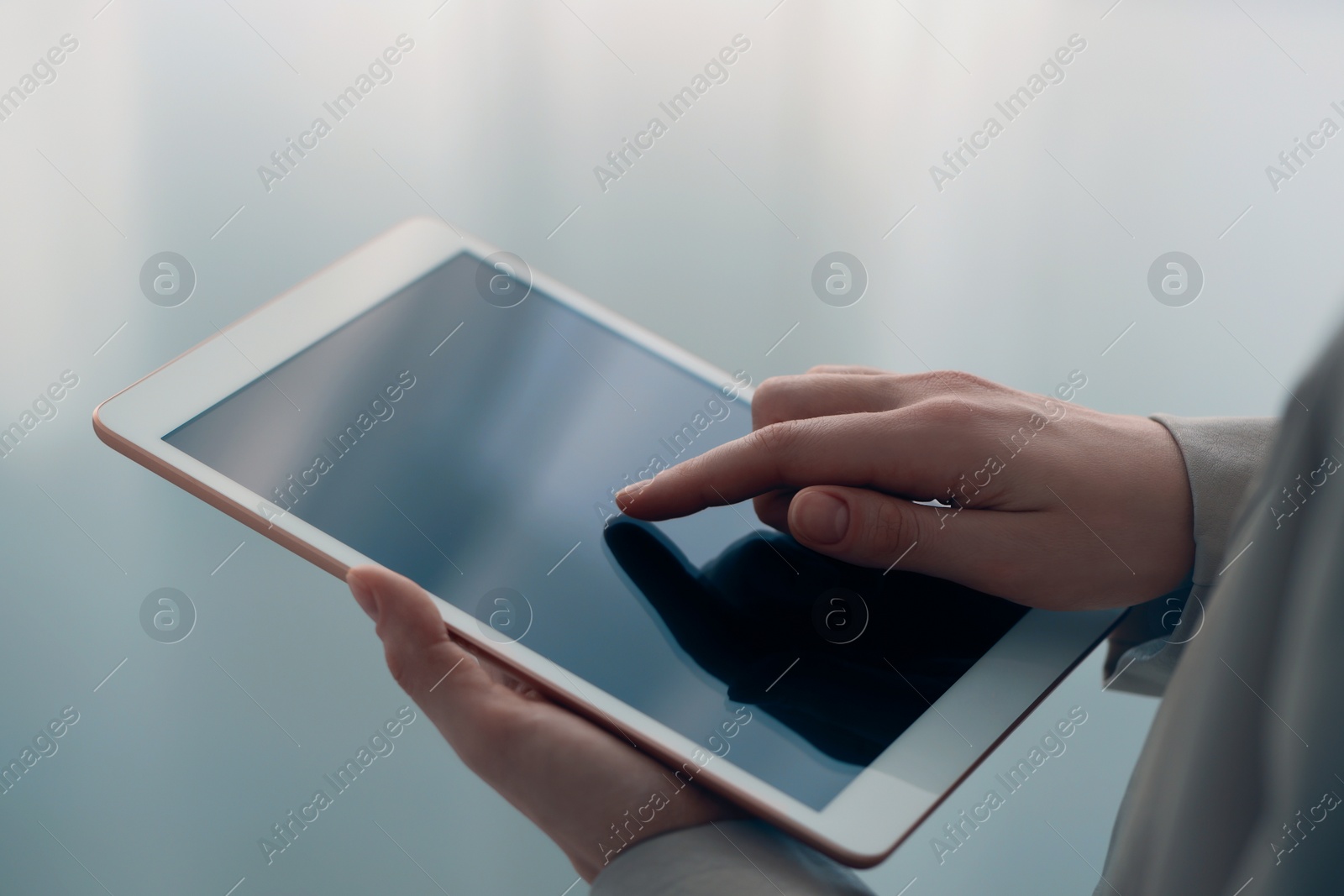 Photo of Closeup view of woman using modern tablet on blurred background