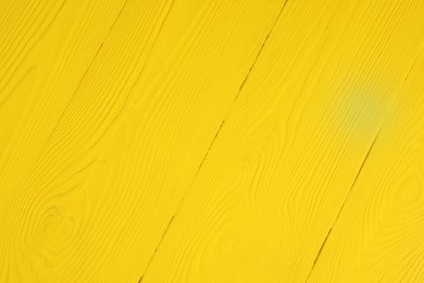 Photo of Texture of yellow wooden surface as background, closeup