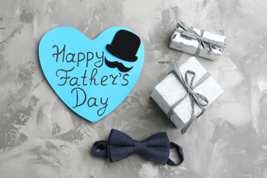 Photo of Flat lay composition with greeting card on light grey stone background. Happy Father's Day