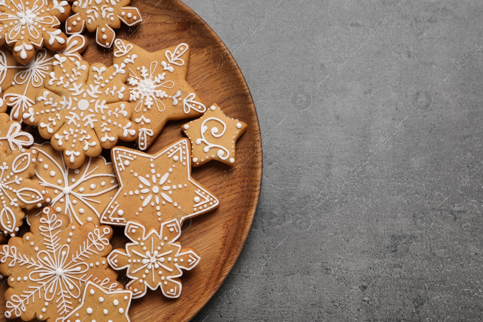 Photo of Tasty Christmas cookies on grey table, top view. Space for text