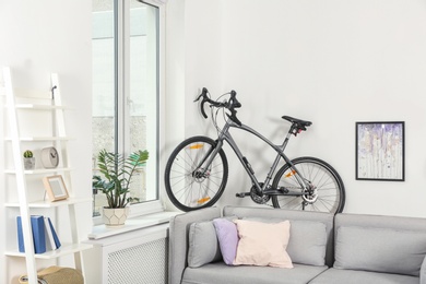 Photo of Modern living room interior with bicycle near wall