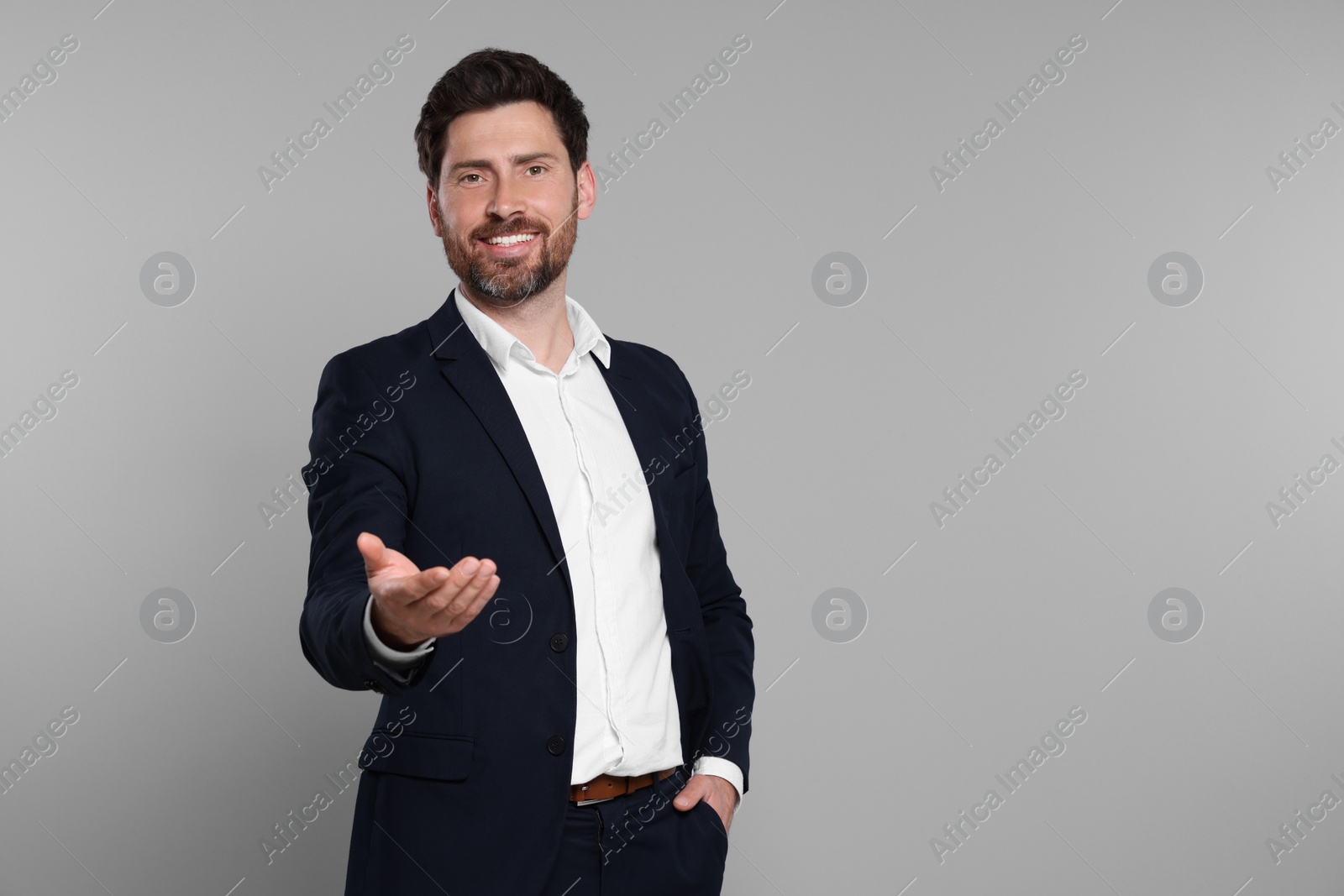 Photo of Happy real estate agent on grey background. Space for text