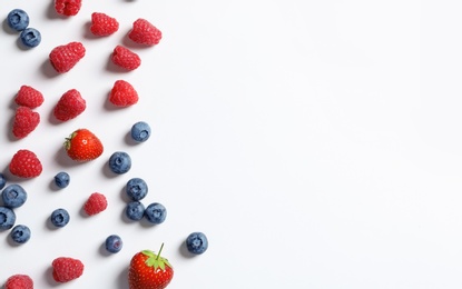 Photo of Raspberries, strawberries and blueberries on white background