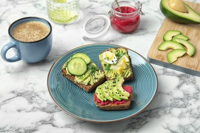 Photo of Crisp rye toasts with avocado on plate