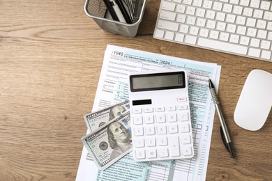 Photo of Tax accounting. Flat lay composition with calculator and document on wooden table, space for text