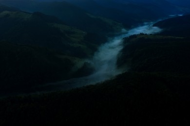 Picturesque view of beautiful foggy mountains with forest in early morning. Drone photography