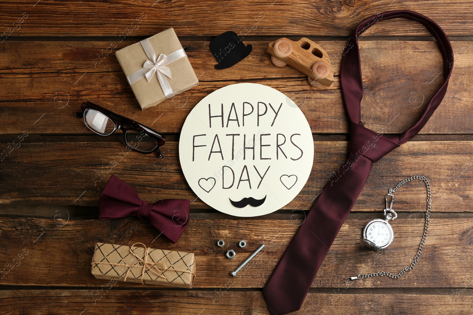 Photo of Flat lay composition of greeting card HAPPY FATHER'S DAY on wooden background