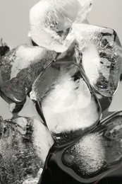Photo of Pieces of crushed ice on grey background, closeup