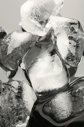 Pieces of crushed ice on grey background, closeup