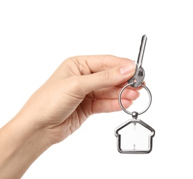 Photo of Woman holding house key with trinket on white background, closeup