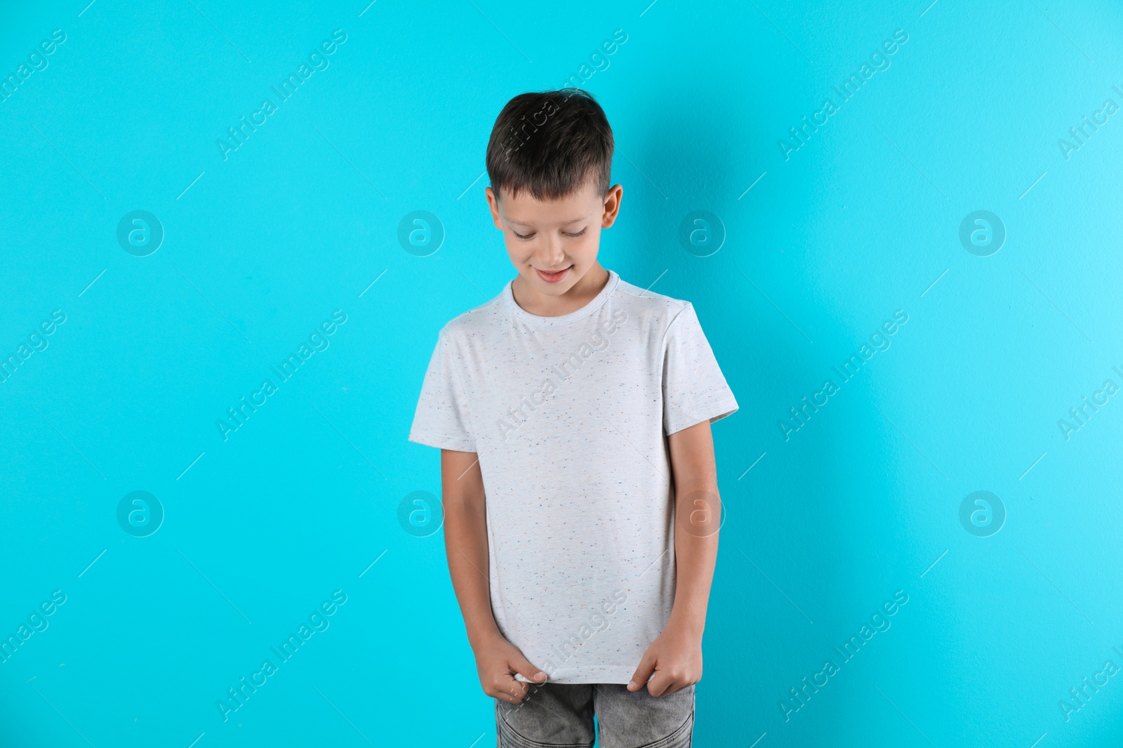 Photo of Little boy in t-shirt on color background. Mock-up for design