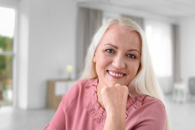 Portrait of beautiful older woman against blurred background