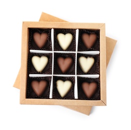 Photo of Tasty heart shaped chocolate candies in box isolated on white, top view. Valentine's day celebration
