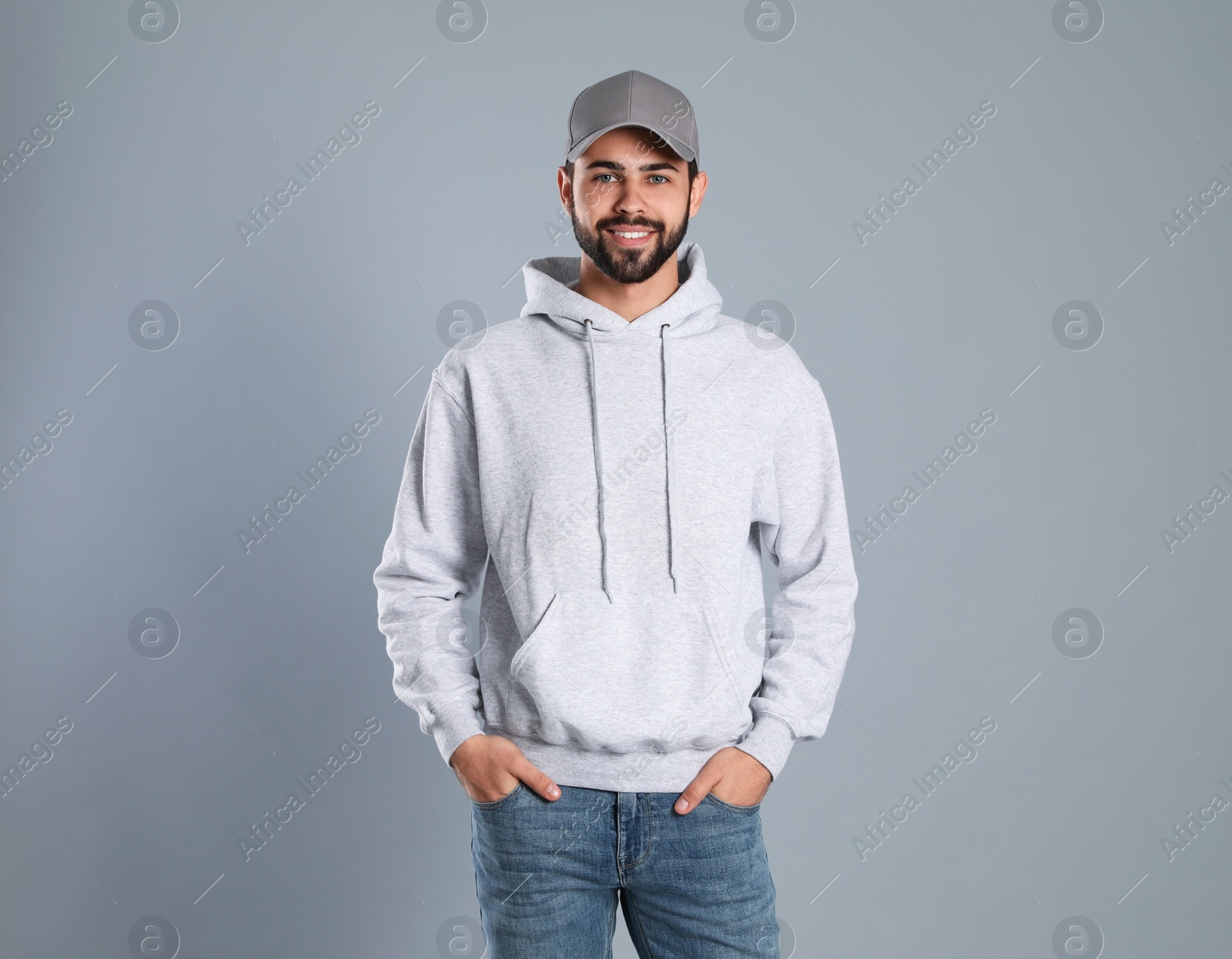 Photo of Portrait of young man in sweater on grey background. Mock up for design