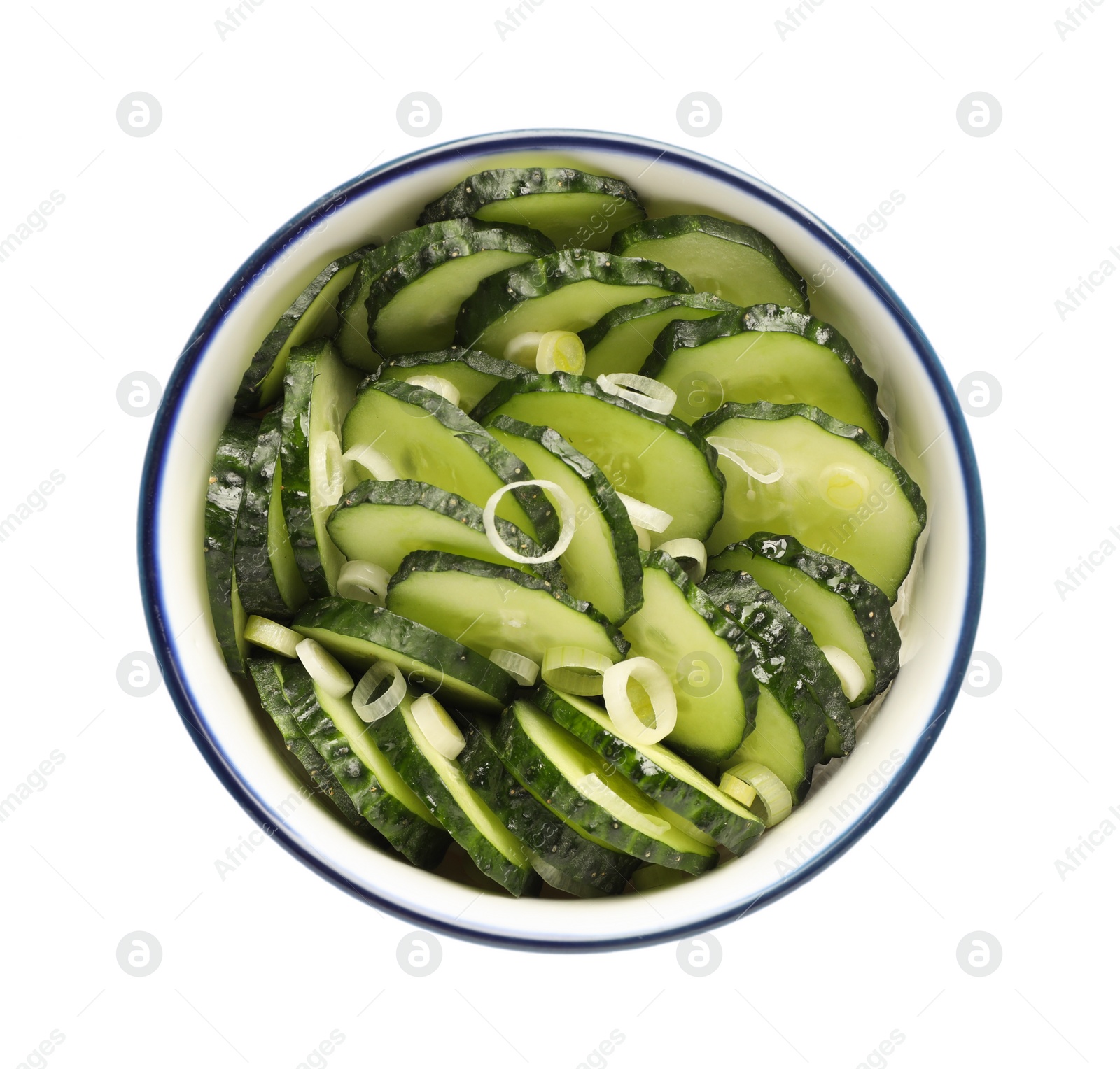 Photo of Appetizing salad with cucumbers and green onion in bowl isolated on white, top view