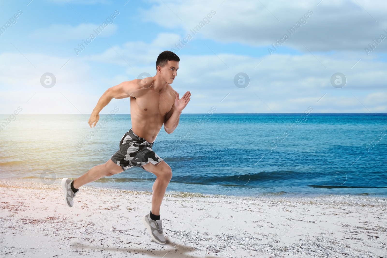 Image of Athletic young man running near sea on sunny day, space for text 