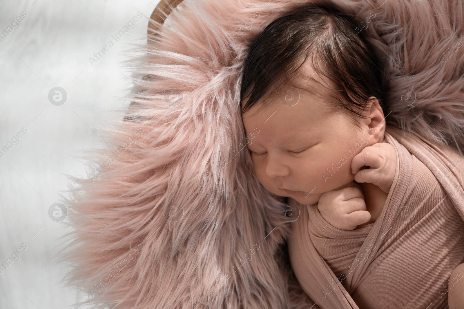 Photo of Cute newborn baby sleeping on fuzzy blanket, closeup