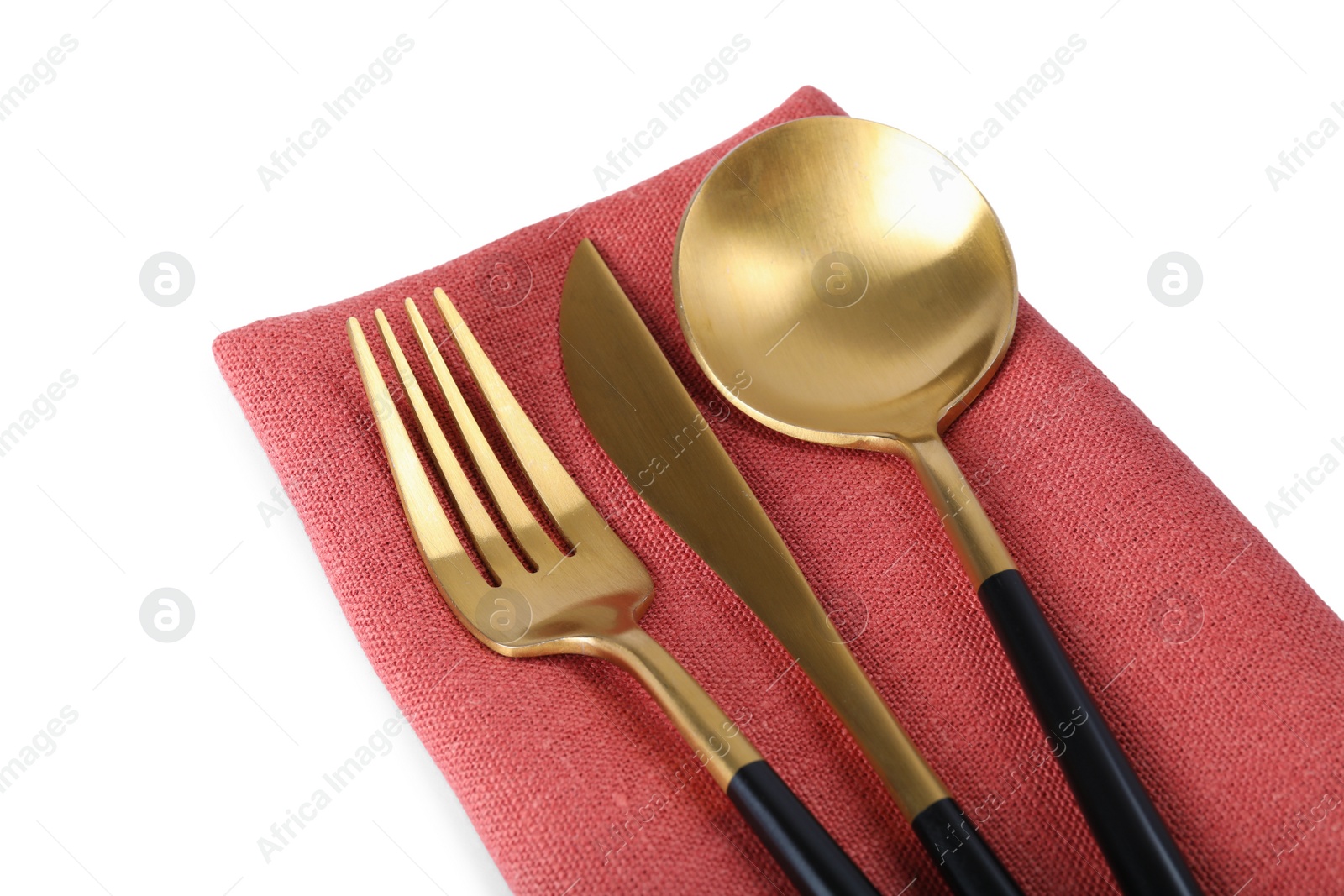 Photo of Coral napkin with golden cutlery on white background, closeup