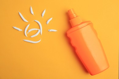 Drawing of sun and bottle with sunscreen on orange background, top view. Skin protection