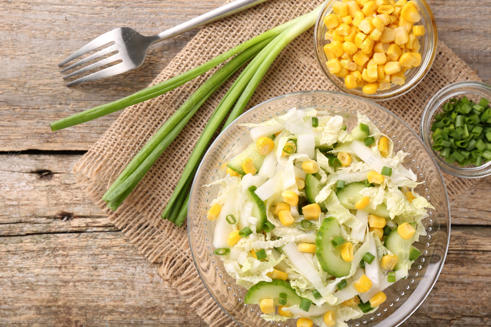 Photo of Tasty salad with Chinese cabbage served on wooden table, flat lay