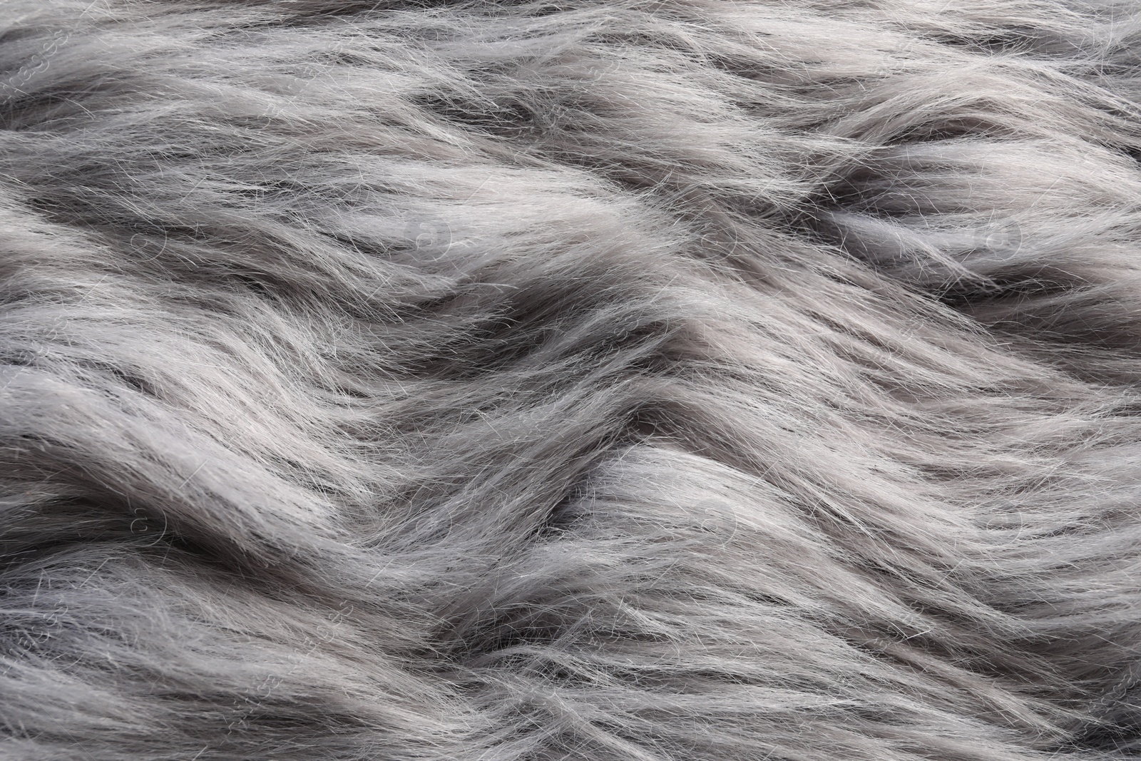 Photo of Texture of grey faux fur as background, closeup