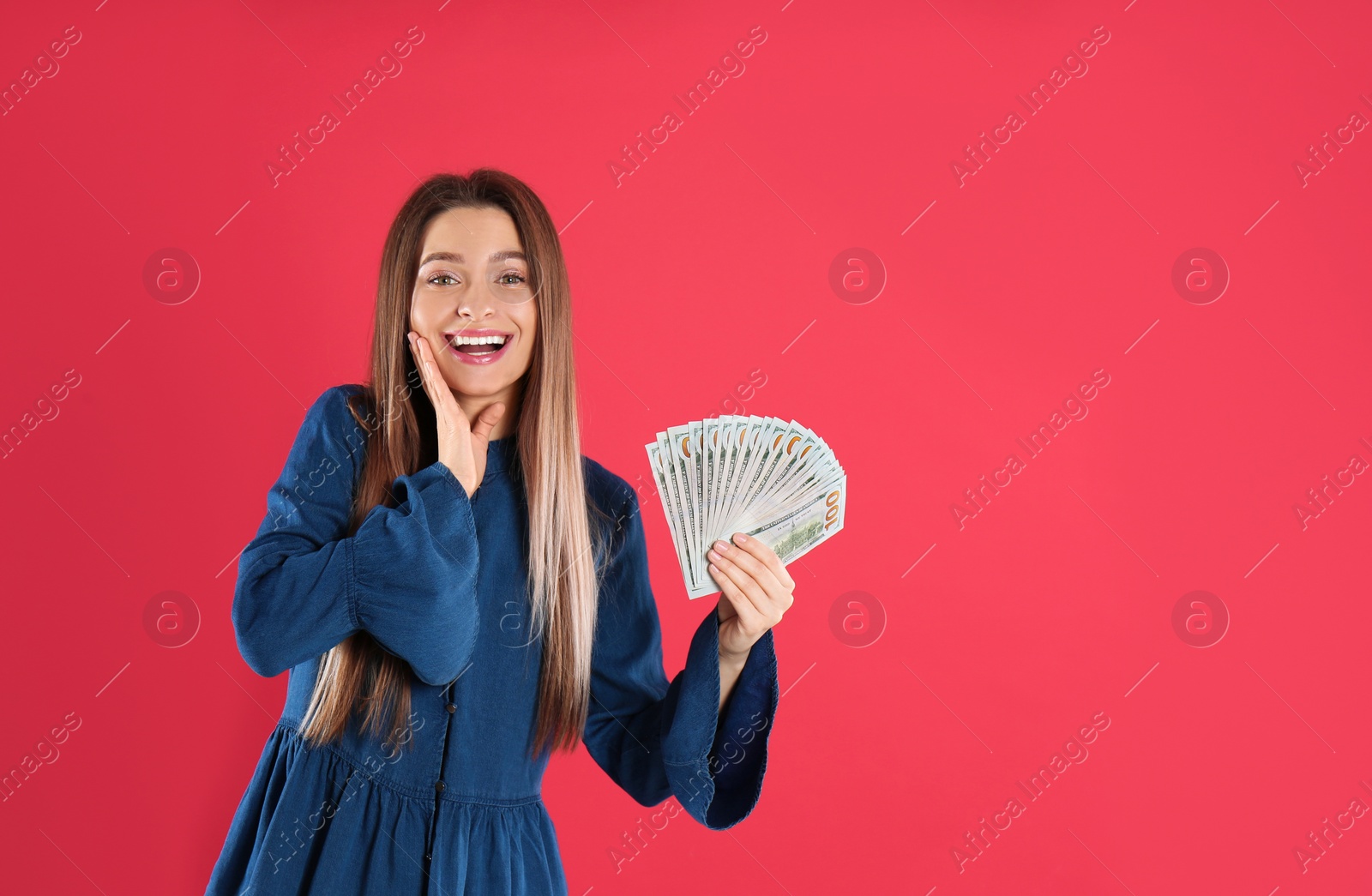Photo of Young woman with money on crimson background. Space for text
