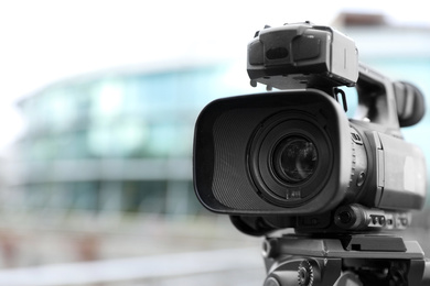 Photo of Professional video camera outdoors, closeup. Space for text