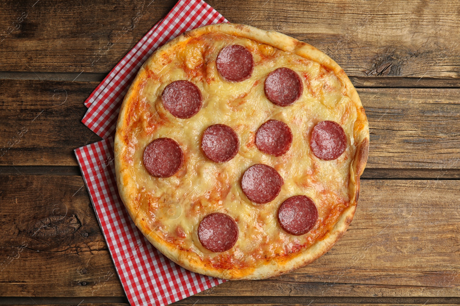 Photo of Tasty pepperoni pizza on wooden table, top view