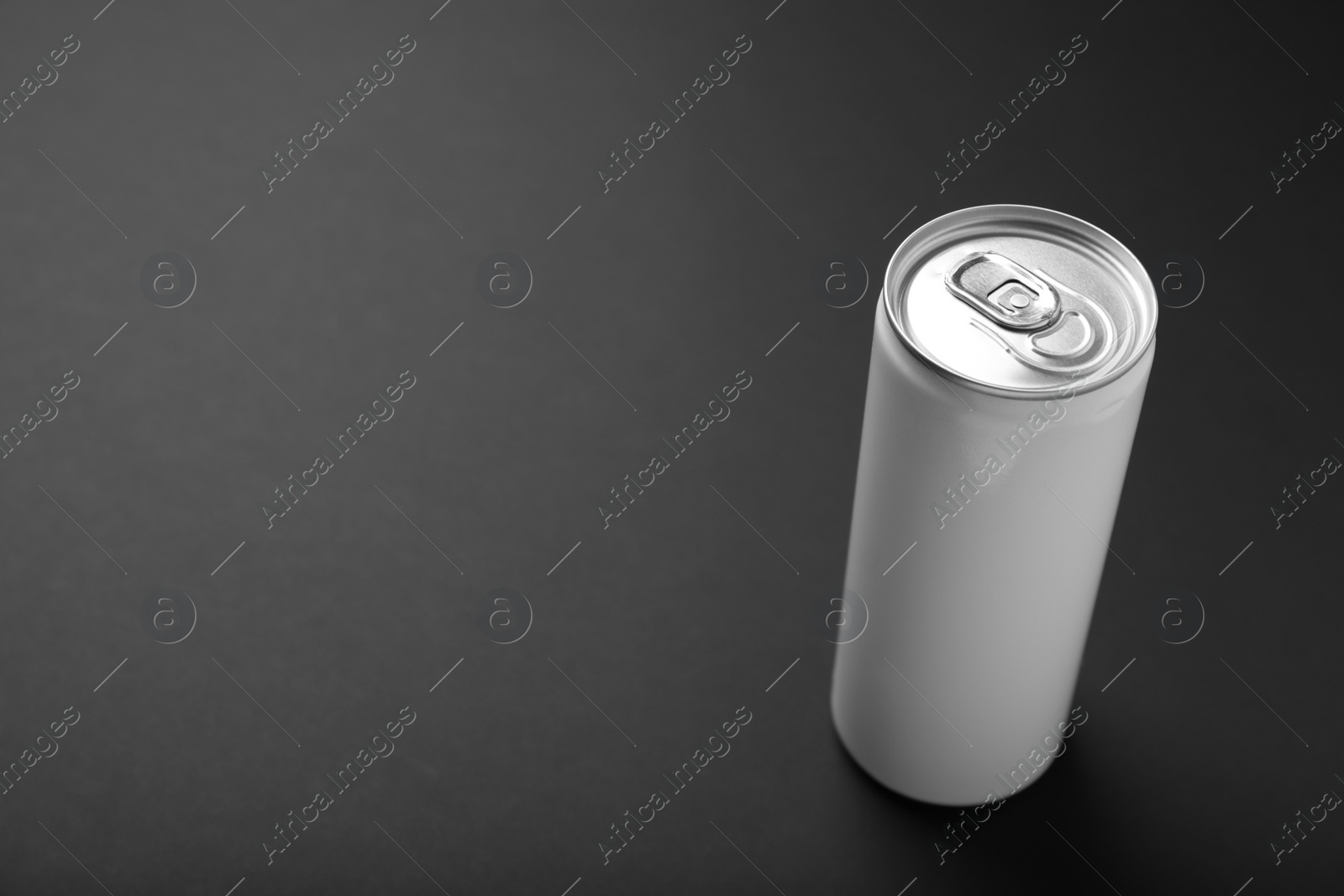 Photo of White can of energy drink on black background. Space for text