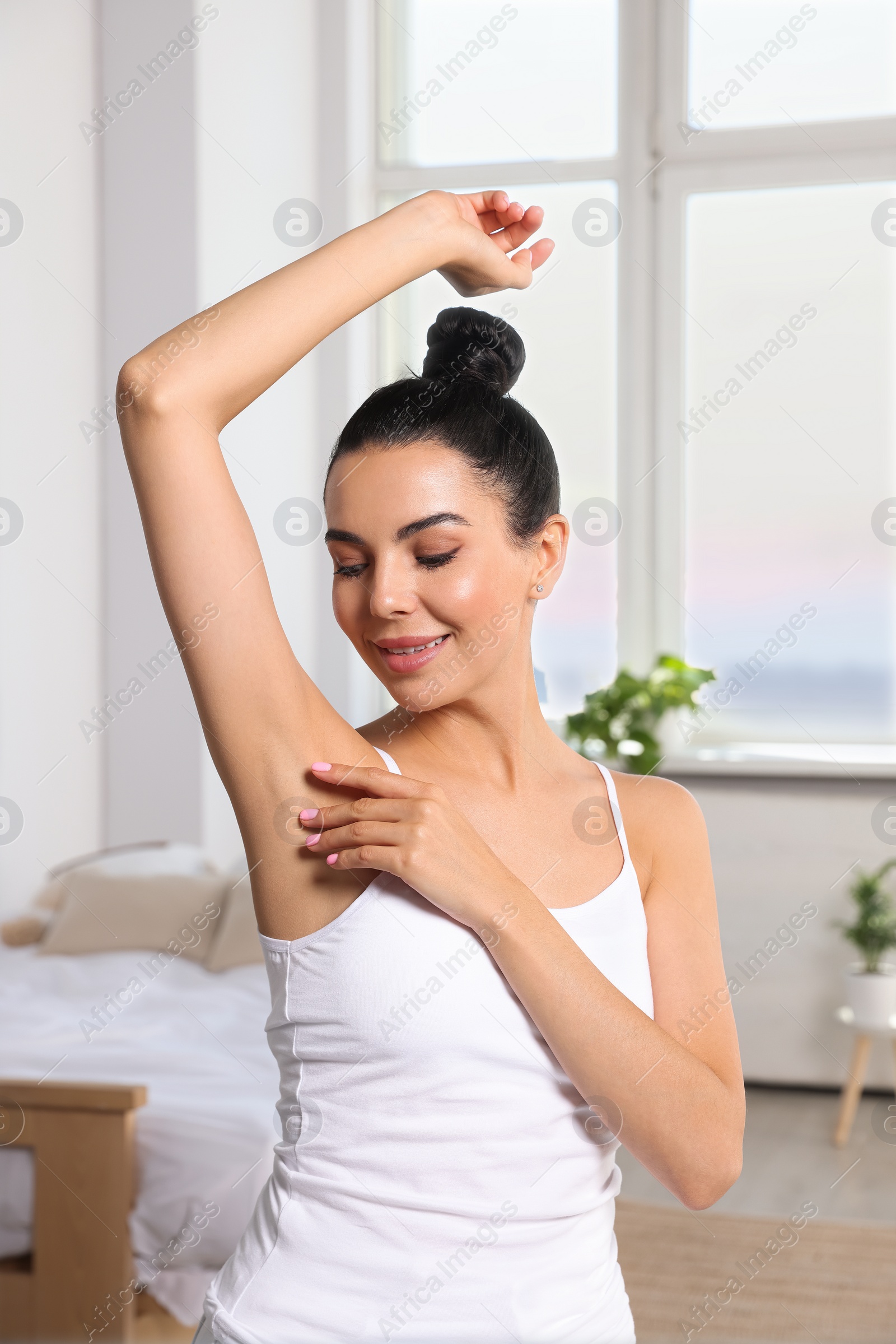 Photo of Young woman showing smooth skin after epilation indoors