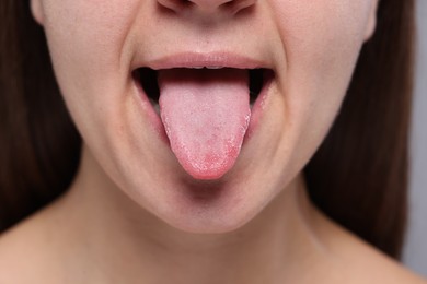 Closeup view of woman showing her tongue