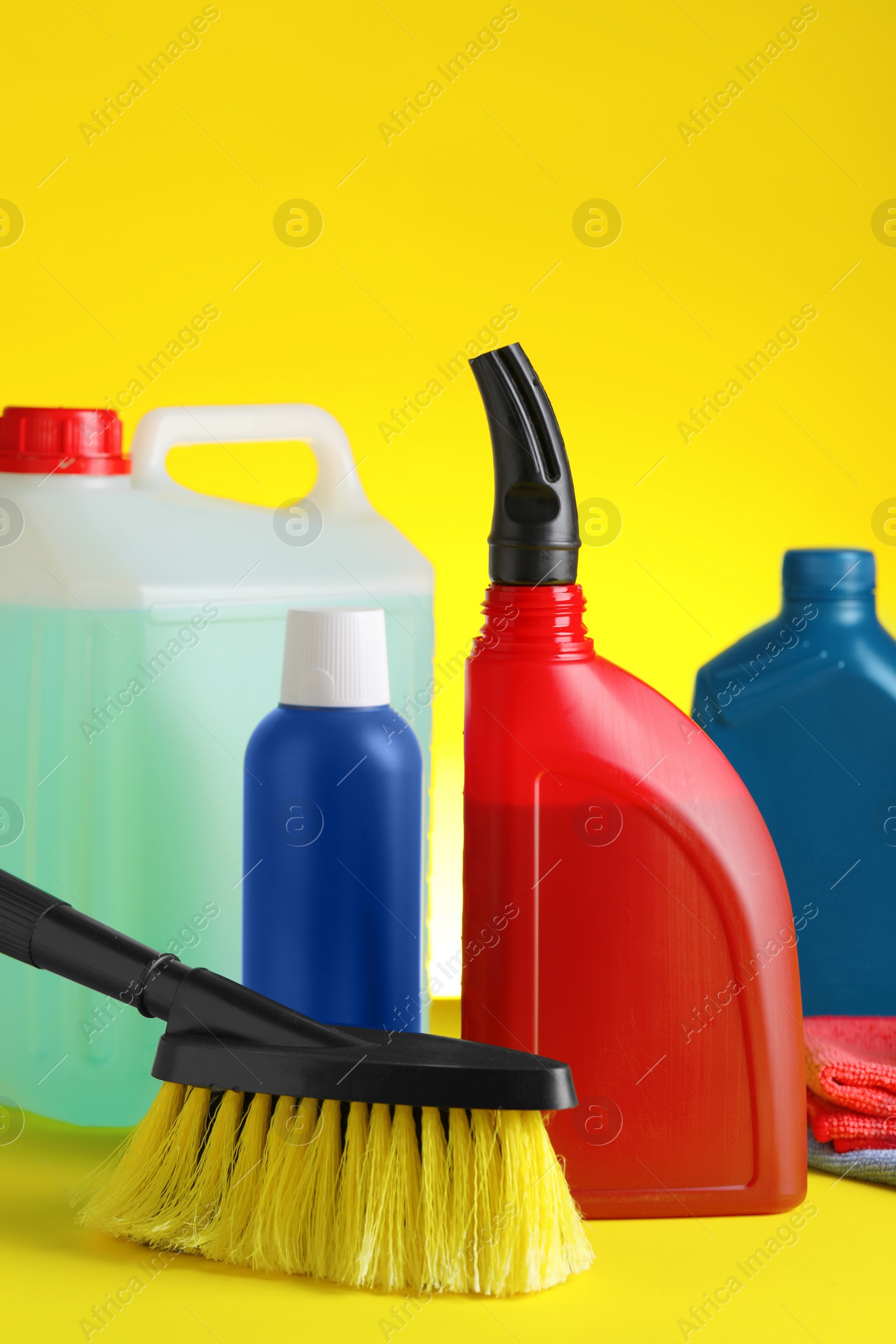 Photo of Different car cleaning products on yellow background