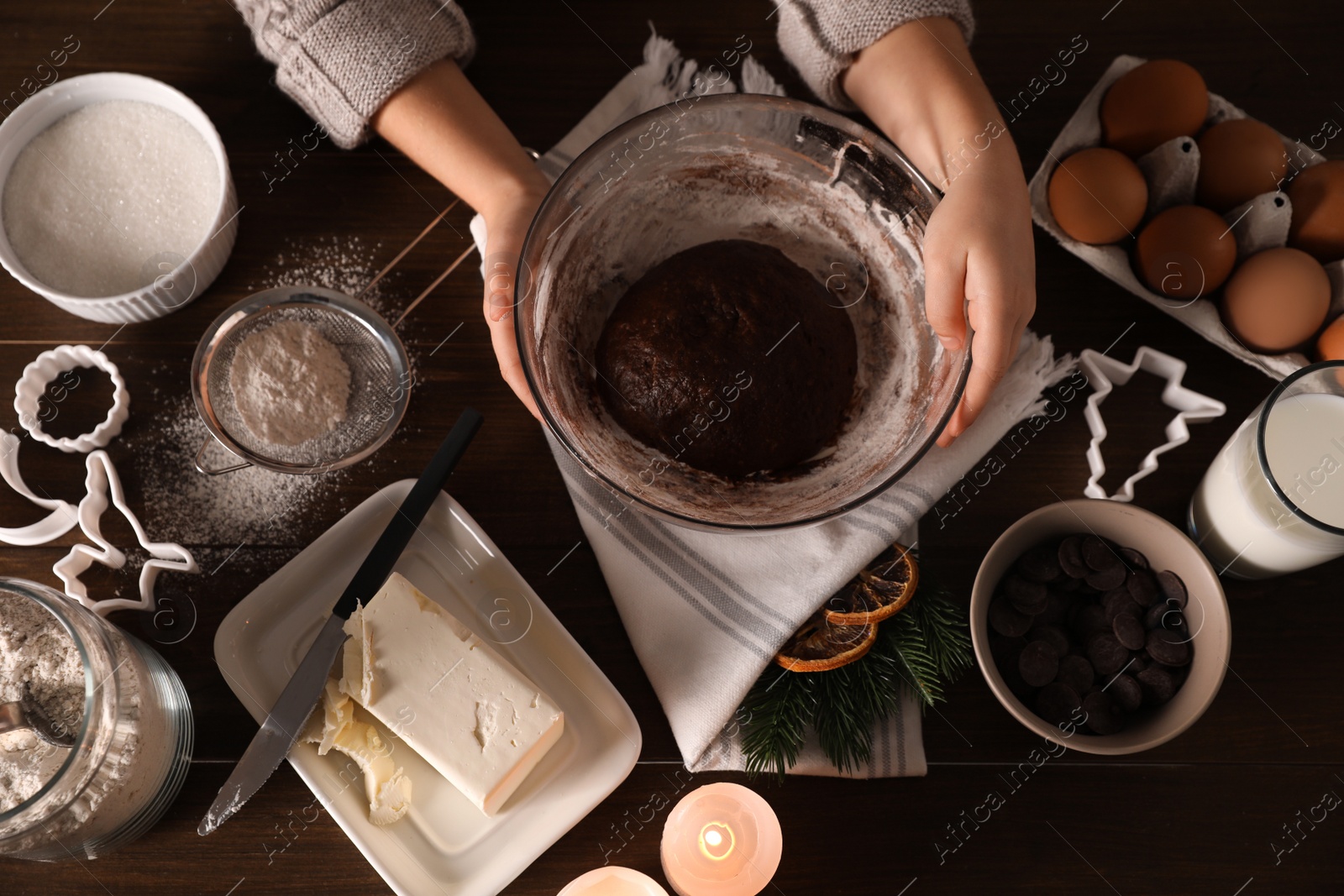 Photo of Little child making Christmas cookies at wooden table, top view
