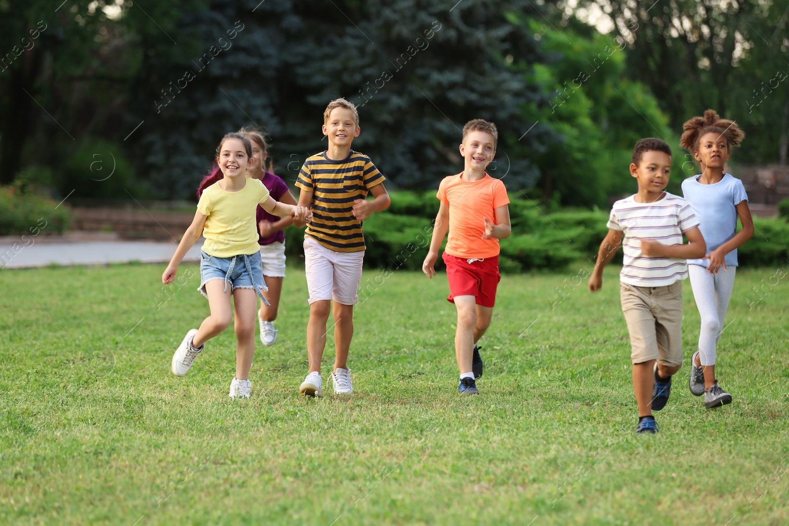 Photo of Cute smiling little children playing in park