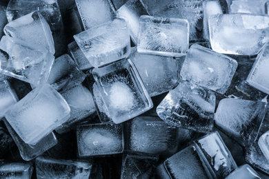 Pile of ice cubes as background, top view