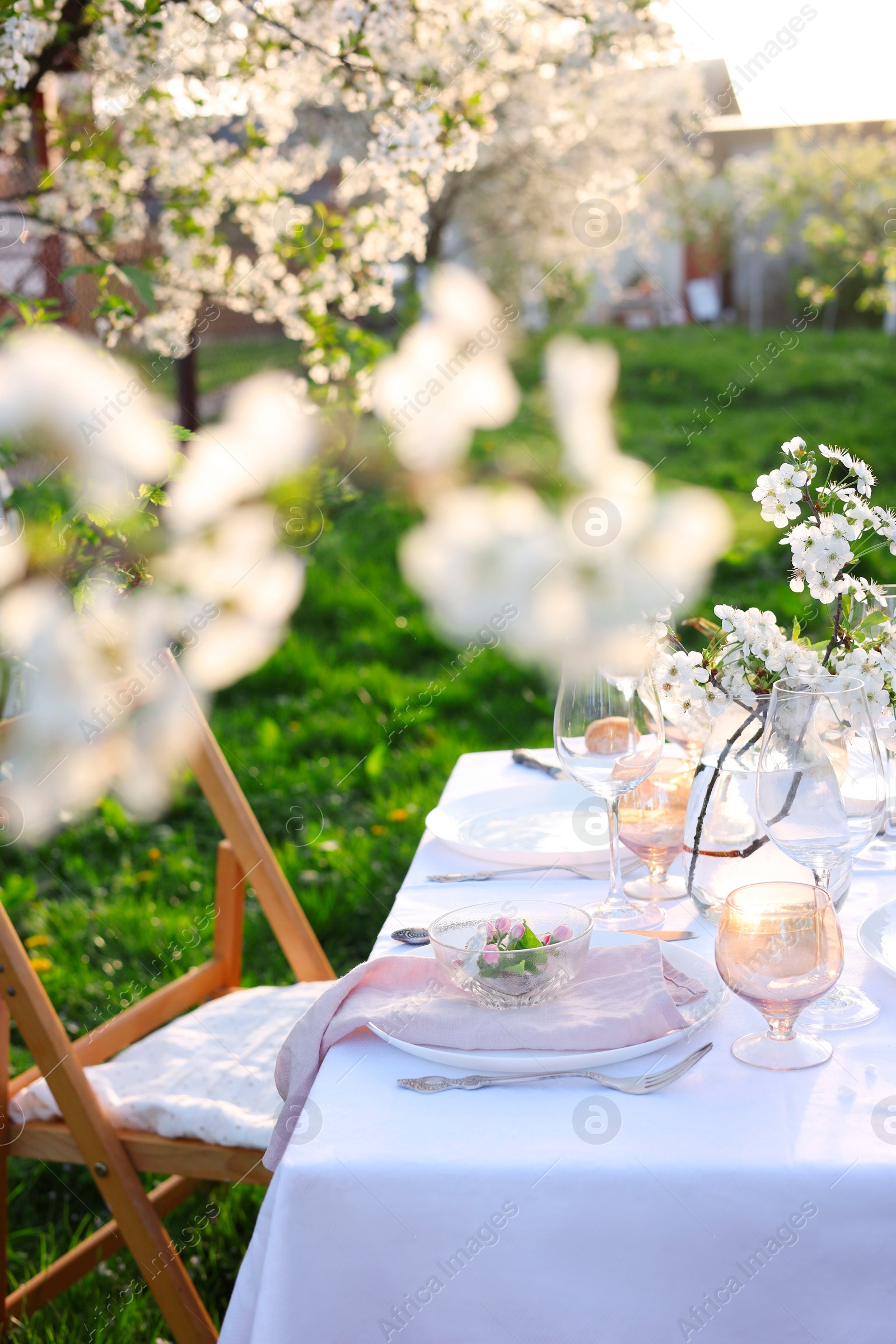 Photo of Stylish table setting with beautiful spring flowers in garden