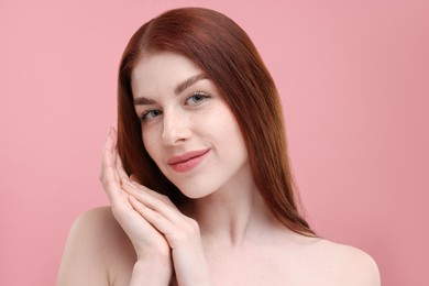 Photo of Portrait of beautiful woman with freckles on pink background