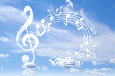 Image of Treble clef and swirly staff with musical notes against sky