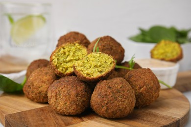 Delicious falafel balls on wooden board, closeup