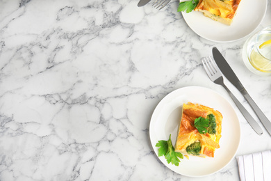 Tasty broccoli casserole served on white marble table, flat lay. Space for text