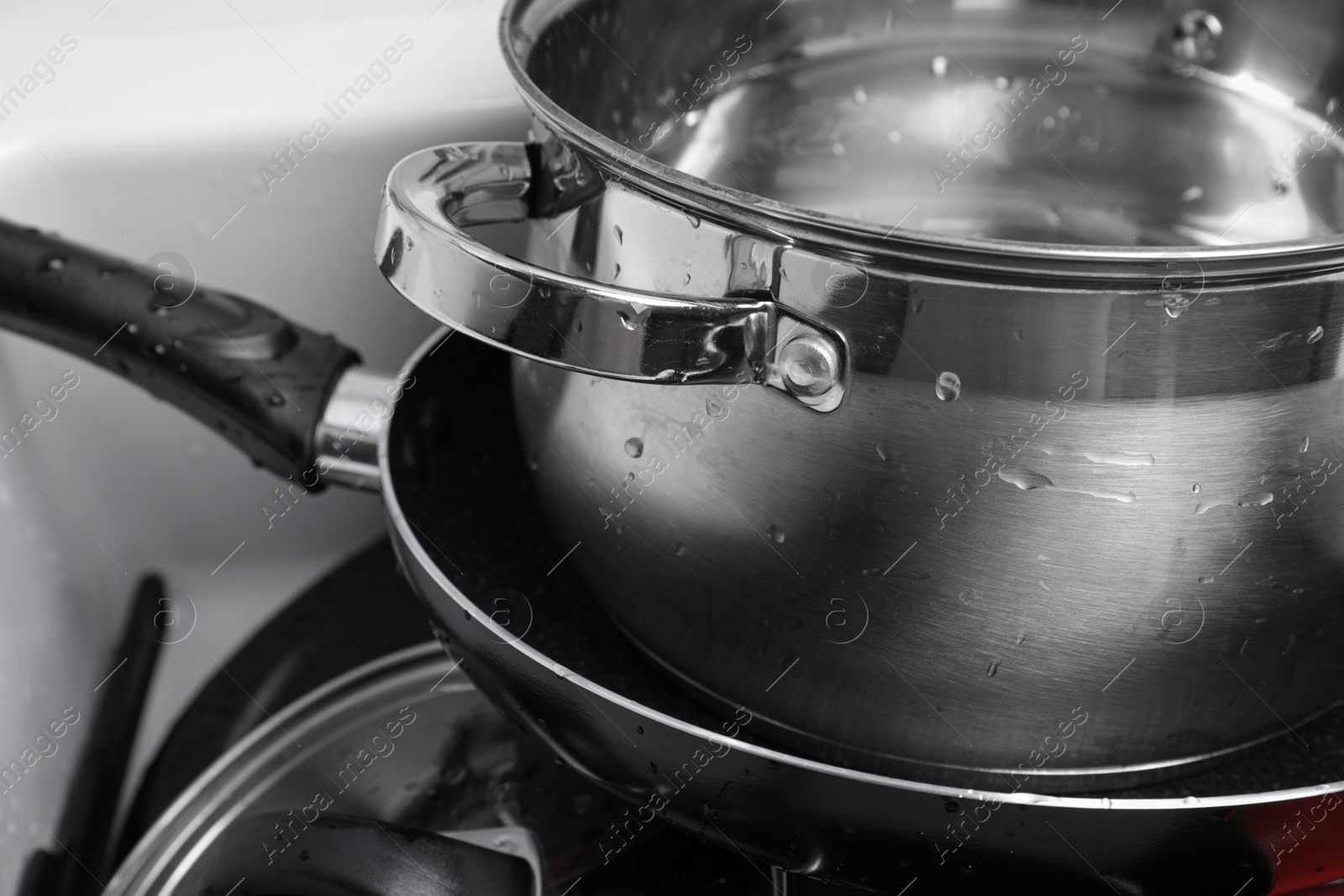 Photo of Stack of clean kitchenware in sink, closeup