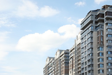 Modern buildings with tinted windows against sky. Urban architecture