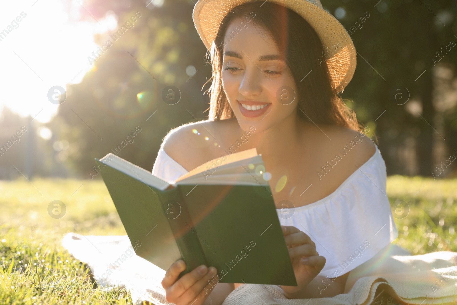 Photo of Beautiful young woman reading book in park