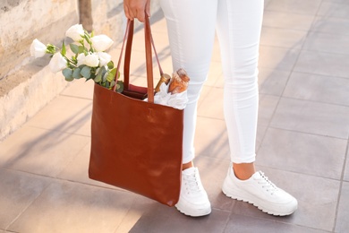 Photo of Woman with leather shopper bag outdoors, closeup