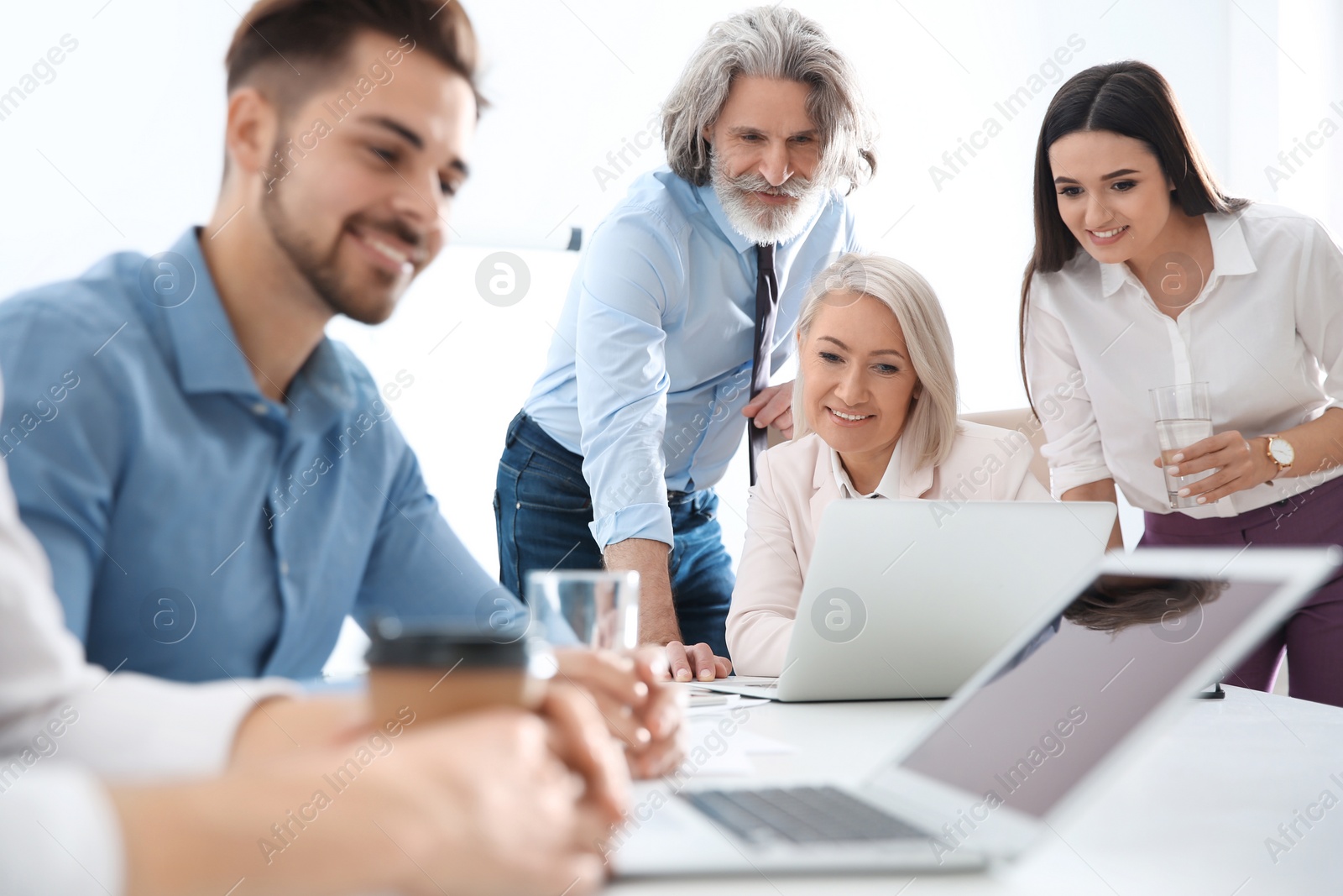 Photo of Business people discussing work matters in office. Professional communication