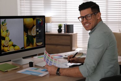 Photo of Professional retoucher working on computer in office